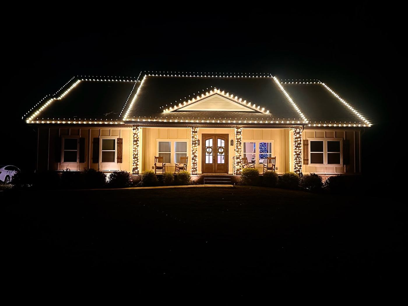 Warm white roofline and porch column lighting on a single-story Southlake home